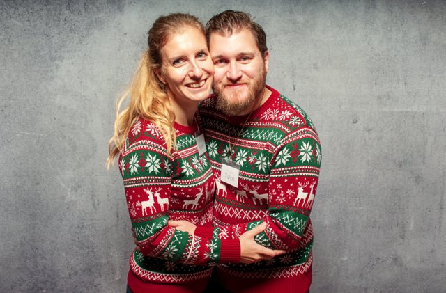 The same couple, dressed by the AI in matching Christmas jumpers
